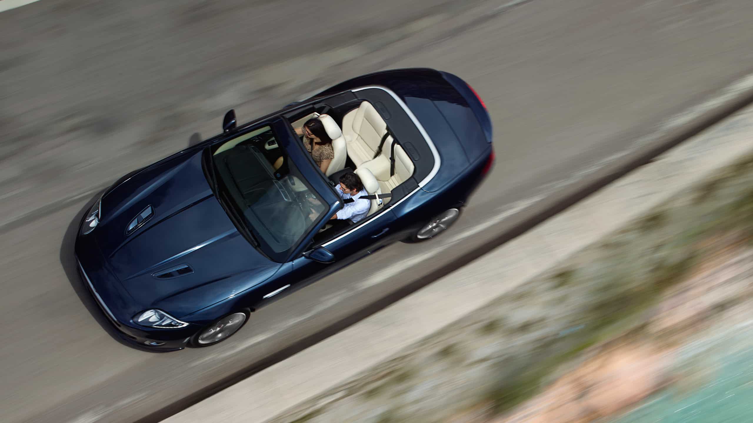 Jaguar XK Moving on Beach Side Road