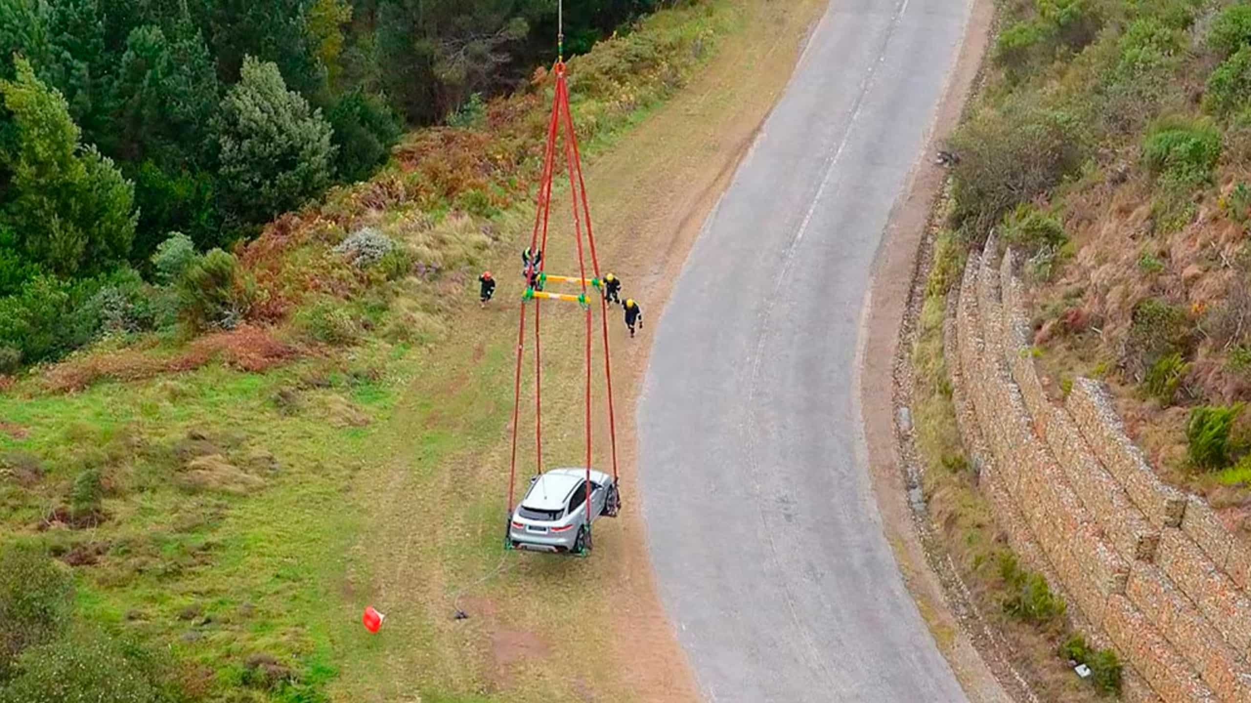 Jaguar F Pace lifting up with the help of Helicopter